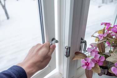 Hand opening window with flower decoration.