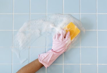 Hand in pink glove with sponge washing