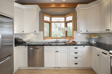 White home showcase interior kitchen with bay window over sink