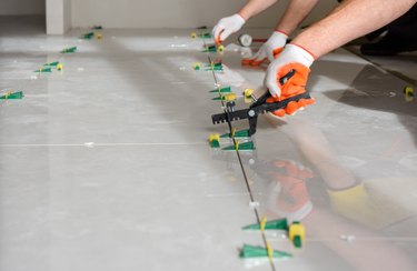 Installing a large ceramic tile.