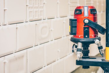 Finishing works - installation of tiles on the wall using a laser level