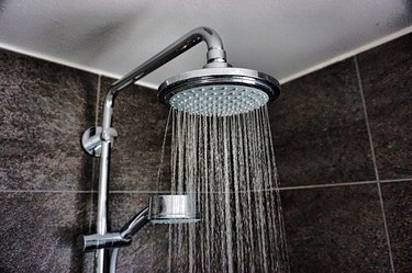 Close-Up Of Water Falling From Shower In Bathroom At Home