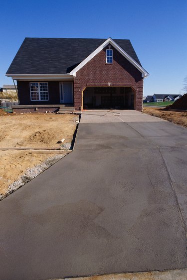 Concrete driveway leading up to new home