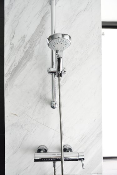 Shower head in a luxury glass and marble shower