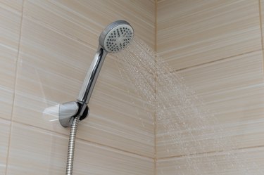 water pours from the shower foliage in the bathroom