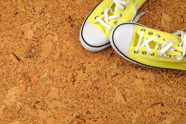 yellow sneakers on a background of cork