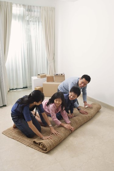 Family unrolling rug