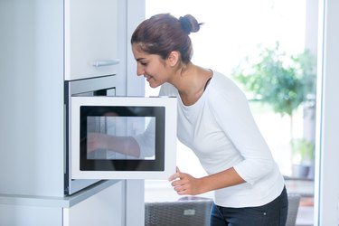 Woman using a microwave