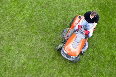 Overhead Shot of Gardener Mowing Lawn with Ride On Mower