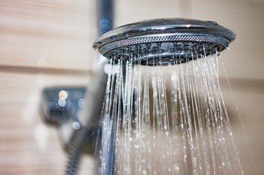 shower head with drops of water falling down