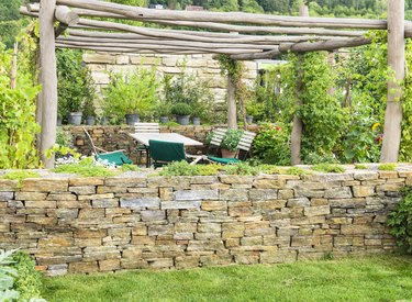 Idyllic garden scene gazebo outdoor furniture stone wall