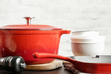 Cookware set: Red enameled cast iron pot, saucepan and bowls