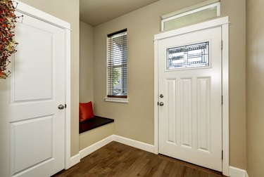 Empty brown entryway interior with white doors
