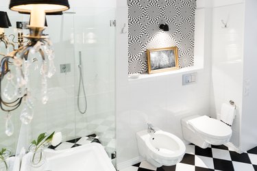Stylish black and white bathroom interior with checkered patterns