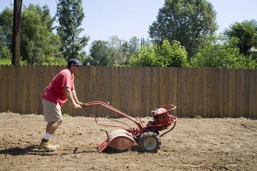 Man using landscaping machine outdoors