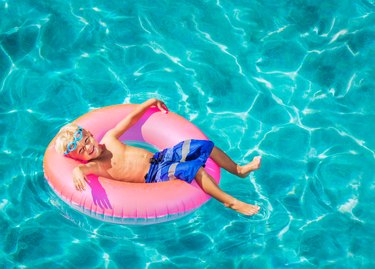 Young child having fun in swimming pool.