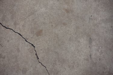 Fissure on light grey concrete slab from above