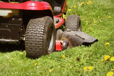 cutting the grass of on a tractor lawn mower