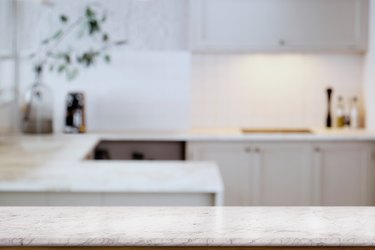 Empty white marble  table top and  kitchen background. for food and product display montage