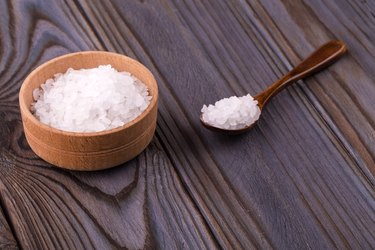 White bath salt in a wooden bow