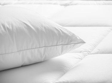 Closeup of white pillow on the bed in the bedroom