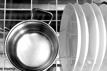 clean dishes and a aluminum pot in the dishwasher