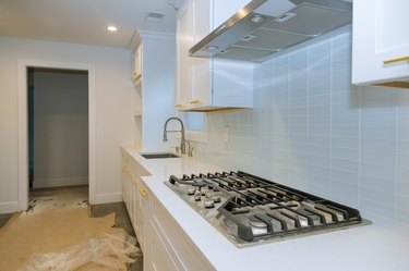Stainless steel kitchen sink and modern kitchen interior with new oven kitchen in the apartment.