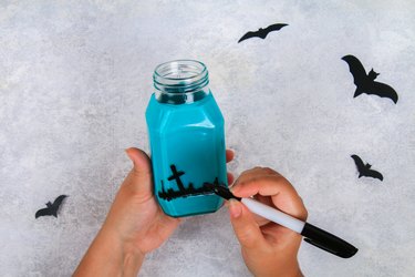 Handicraft from a jar. Bats on a light table. The concept for Halloween. DIY.
