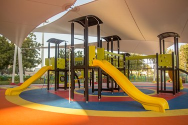 Shaded kid's playground activity tower equipment at the Lake park in Abu dhabi