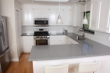 Classic White Domestic Kitchen with Subway Tile and Quartz Counters