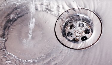 Water running down steel sink drain