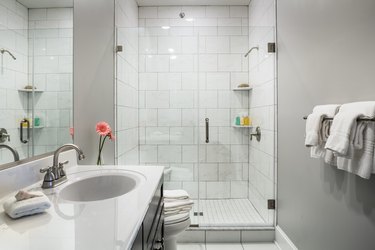 Bathroom interior with walk in shower and gray paint