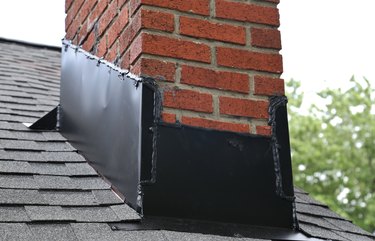 Close-Up Of Brick Chimney On House Roof With medal flashing