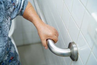 Asian senior or elderly old lady woman patient use shower handle security in nursing hospital ward : healthy strong medical concept.