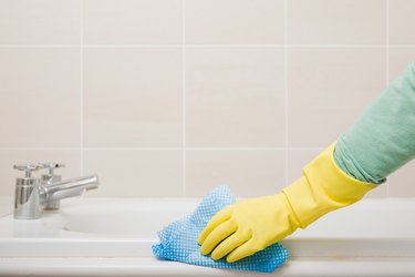 Person cleaning bath