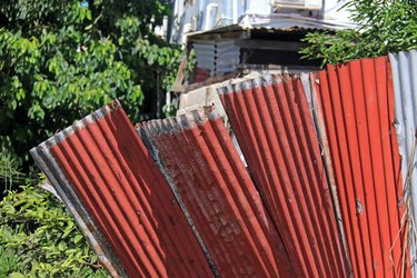 Old corrugated tin sheets used as fence in a developing country