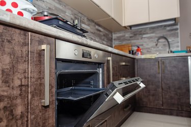 Modern kitchen interior in wenge colors with built-in appliances