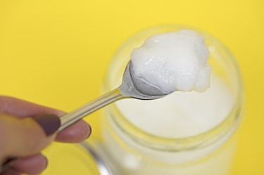 Coconut oil in jar with spoon