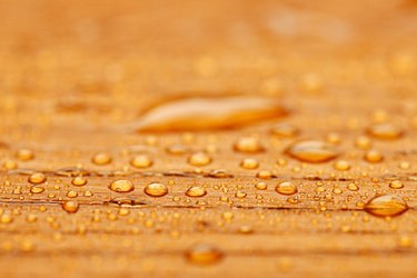 Protected wood after rain - covered with water drops