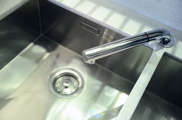 New kitchen sink made of stainless metal. The concept of modern kitchen interior.