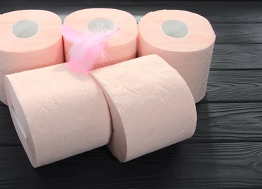 Pink toilet paper is on the table.