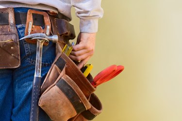 Young Construction Worker Reaches Into His Tool Belt Copy Space