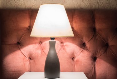 Close-Up Of Electric Lamp On Table At Home