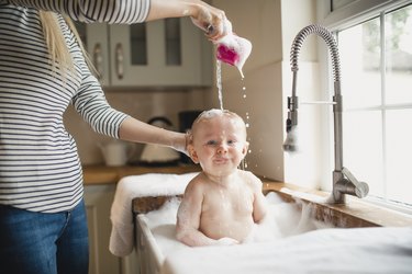 Mother washes baby