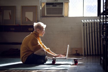 Woman using laptop computer while sitting at home