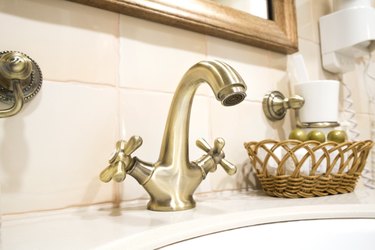 Retro faucet in bronze in the bathroom of the hotel