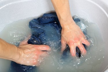 Washing clothes by hand.