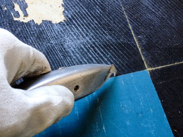 close up of worker removing flooring