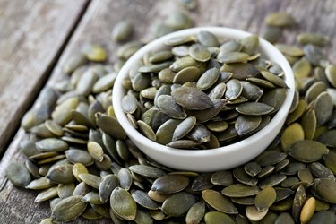 pumpkin seeds on wooden surface