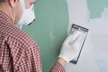 Sanding the drywall mud